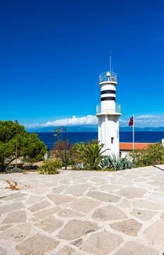 White lighthouse on the shore Fotos Stock