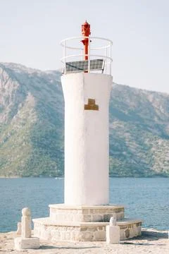 White lighthouse with solar panel on Our Lady of the Rocks island Montenegro Stock Photos