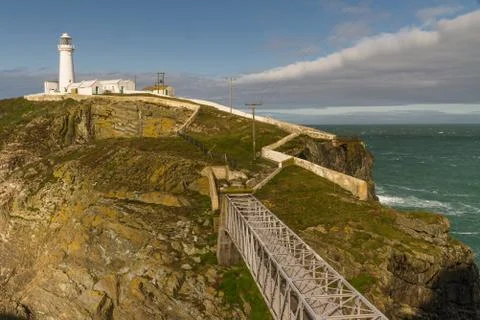 White lighthouse at South Stack with footbridge. Stock Photos