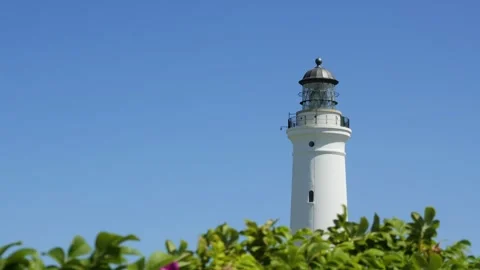 White lighthouse tower against a clear blue sky Video stock 338329337