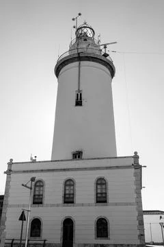 White lighthouse tower at the beach. Stock Photos