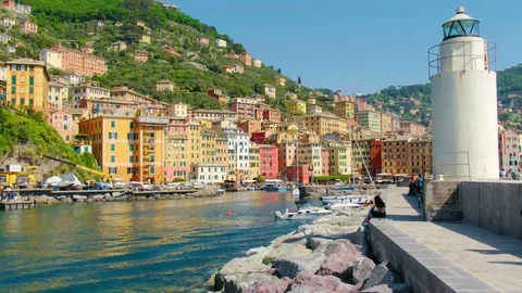 White lighthouse town pier - colored buildings - camogli on sunny day - italian Stock Footage 90302620