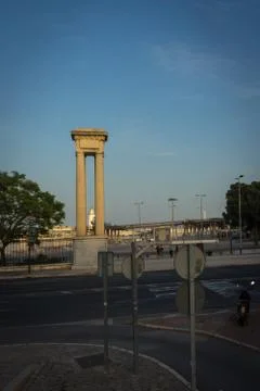 White lighthouse viewed through a pillar in Malaga, Spain, Europe Stock Photos
