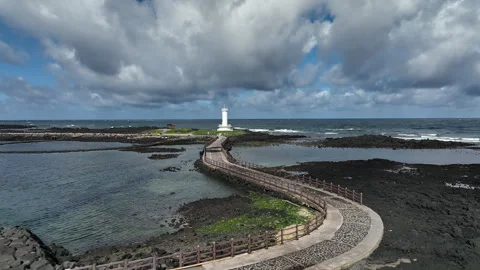 White lighthouse on a winding pier path, South Korea Vídeos de archivo 346715828