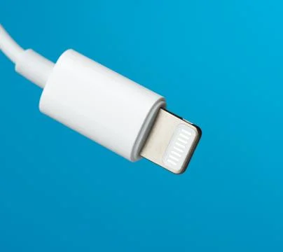 White lightning cable on a blue background Stock-Fotos