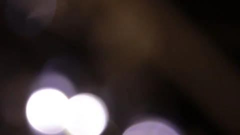 White lights moving closer and further away on a black background Vídeo Stock 309341793