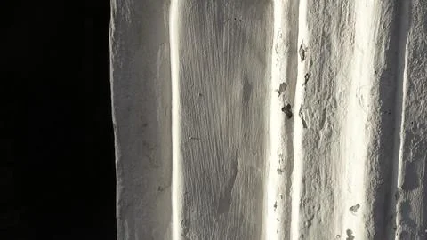 White Lime Wall With Textured Edges Illuminated by Soft Light Stock Photos