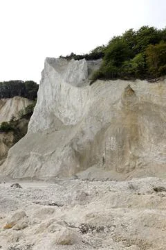 White limestone cliff being eroded by natural elements with plants s at ris.. 스톡 사진