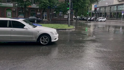 White limousine smoothly touches from the intersection and the passenger waves Stock Footage 131531154