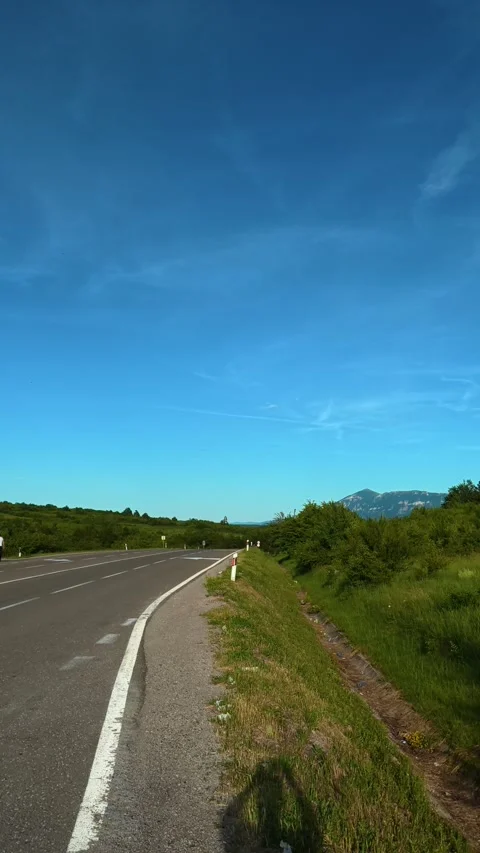 White line marks edge of asphalt. Mount Rtanj Area. Vertical Stock Footage 340899022