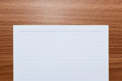 White line paper with space for text on brown wooden table, top view Stock Photos