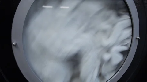 White linen in the Laundry spinning in inside the  washing machine 스톡 동영상 104023409