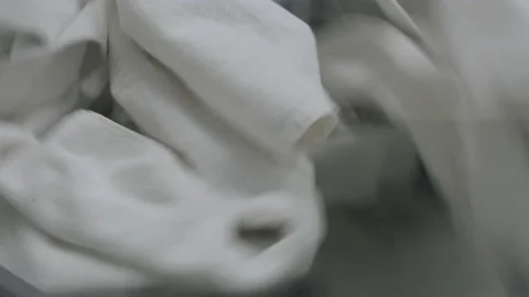 White linen rotates in the washing machine Stockbeeldmateriaal 221706549