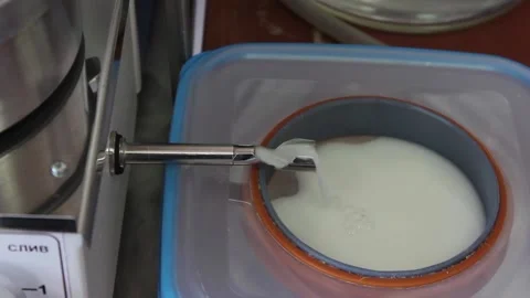 White liquid flows out of the laboratory apparatus. Stock Footage 128374717