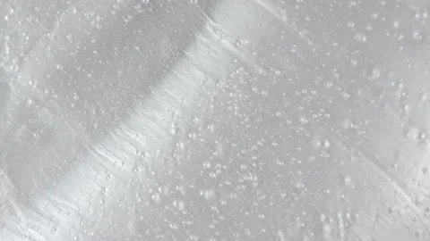 White liquid gel background, clear serum texture. Motion, rotation of the beauty Stock-Footage 149769705