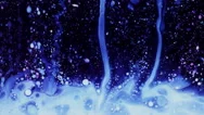 White Liquid, Pink And Blue Bubbles Descending In Dark Water, Close Up Stock Footage