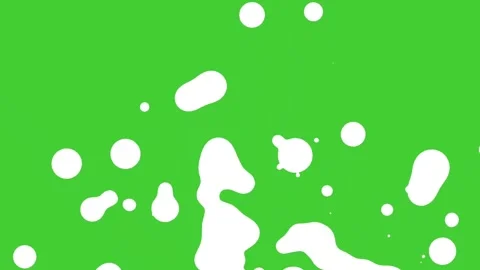 White liquid splashes in motion on vibrant green screen background Stock Footage 314615306