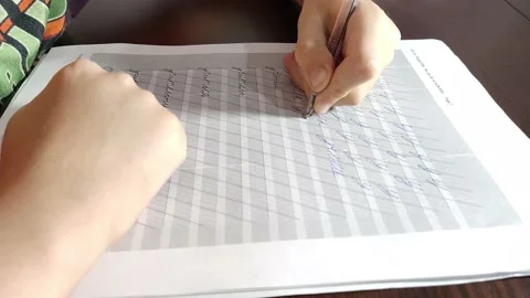 A white little child learns to write beautifully in Cyrillic Stock Footage 163839578