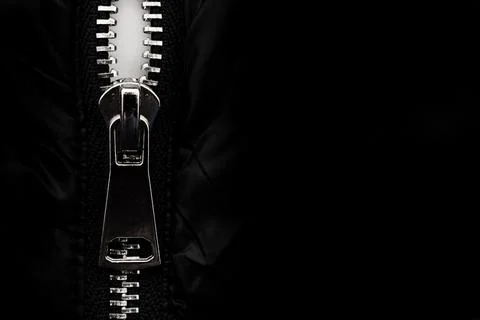 White lock with a zipper on clothes, jacket, jacket close-up on a black Stock Photos