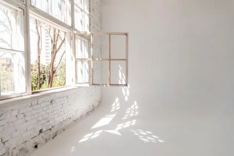 A white loft with a large open window. photographic studio. Stock Photos