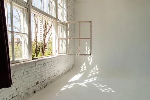 A white loft with a large open window. photographic studio. Stock Photos