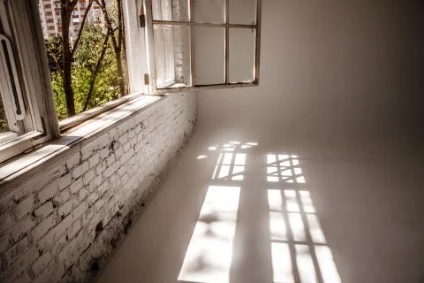 A white loft with a large open window. photographic studio. Stock Photos