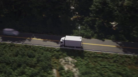 White logistics vehicle carrying the ordered supply items on the roadway Stock Footage 319271422
