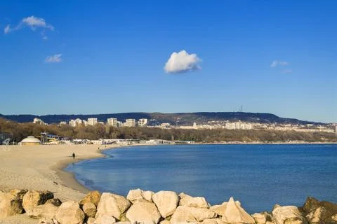 White lonely cloud high in the blue sky over the Bay of Varna Stock Photos
