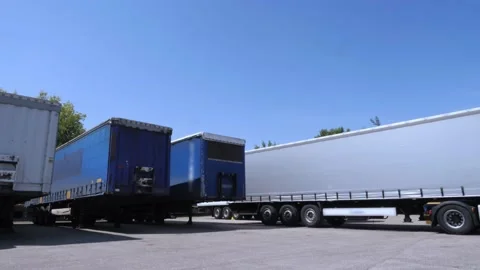 White lorry with cargo trailer drives back into parking place. Stock Footage 153052449