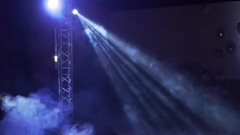 A white luminous beam with the effect of smoke and dust particles directed at Stock Footage 248162102