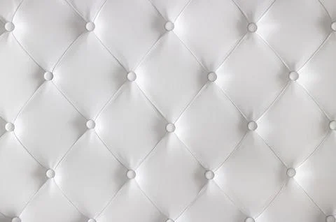 White luxurious diamond pattern leather upholstery with buttons. Stock Photos