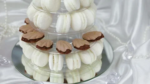 White macaron tower and shell shaped chocolate cookies at a candy bar Stock Footage 334676337