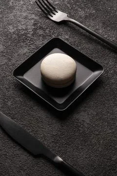 White macaroon cake in a square plate. stylish minimalistic close-up photo Stock Photos