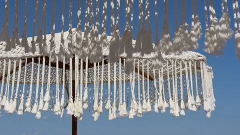 White Macrame Fringe Hanging Against Clear Blue Sky 4K Video Stock Footage 342686788