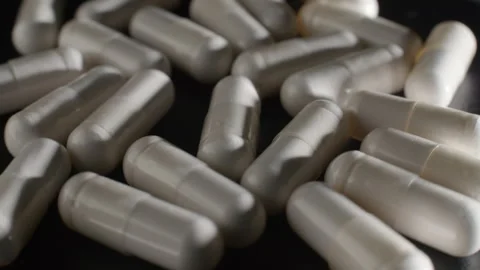 White Magnesium Capsules on Rotating Platform Video stock 332367351
