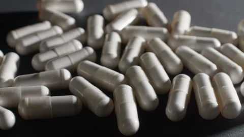 White Magnesium Capsules Static Macro Video stock 332367744