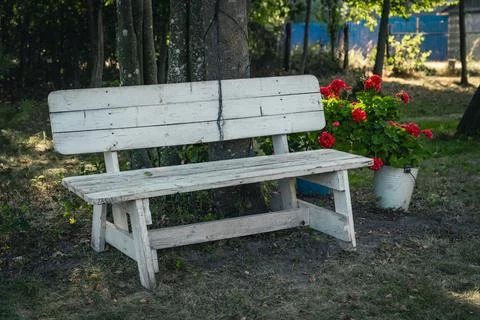 A white, makeshift bench in the backyard of the site. A courtyard in the vi.. Stock Photos
