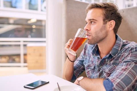 White male looking off camera while sipping his tea Stock Photos