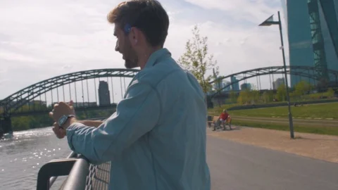 White male model having a good time next to the river in a bright outfit leaning Video stock 87261024