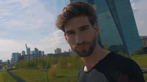 White male model posing on a bridge in frankfurt next to ecb Stock Footage 87260885