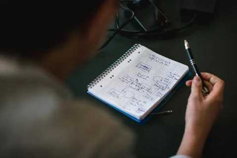 White male taking notes about Blockchain on notebook Stock Photos