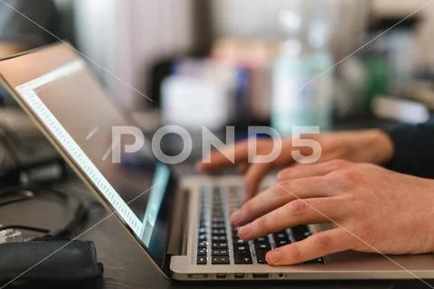 White male typing on MacBook Stock Photos