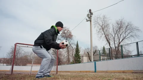 White man crouched and ready with soccer ball in hands, anticipatory goalie Video stock 323218081