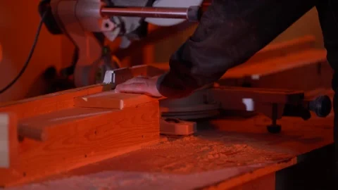 White man cuts a bar with a circular saw in the workshop another angle Stock Footage 120599715