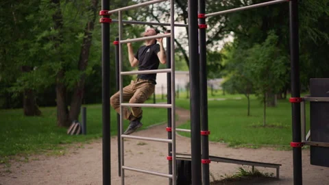 White Man Doing Pullups On Calisthenics Rig, Gripping Bars With Controlled Form Stock Footage 327167677