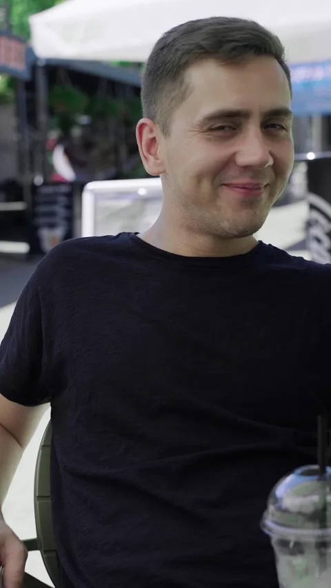 White man drinking a refreshing cocktail, outdoor café Stock Footage 279163960