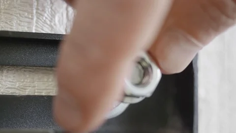 White man hand twists nut of wall TV bracket with wrench. Extreme close-up view Stock Footage 126209745