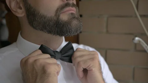 White man hands putting bow tie detail Stock Footage 115665185