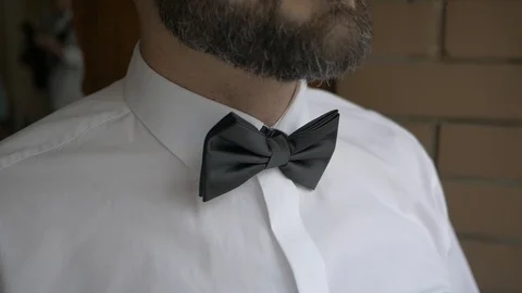 White man hands putting bow tie detail Stock Footage 115992905
