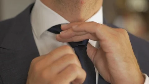White man hands putting tie  Stock Footage 115903165